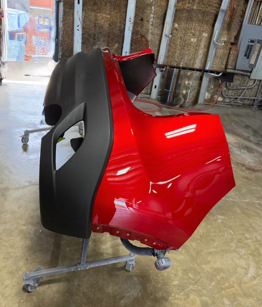 A textured bumper cover on a repair stand